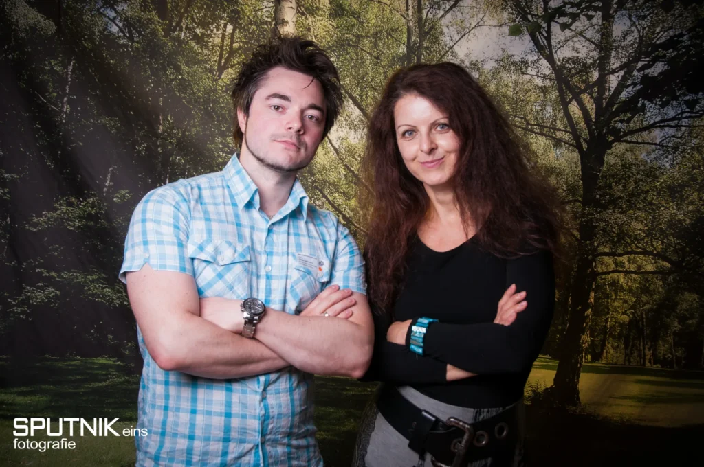 Oli und Sibylle Sterzer mit verschränkten Armen vor einer Waldkulisse